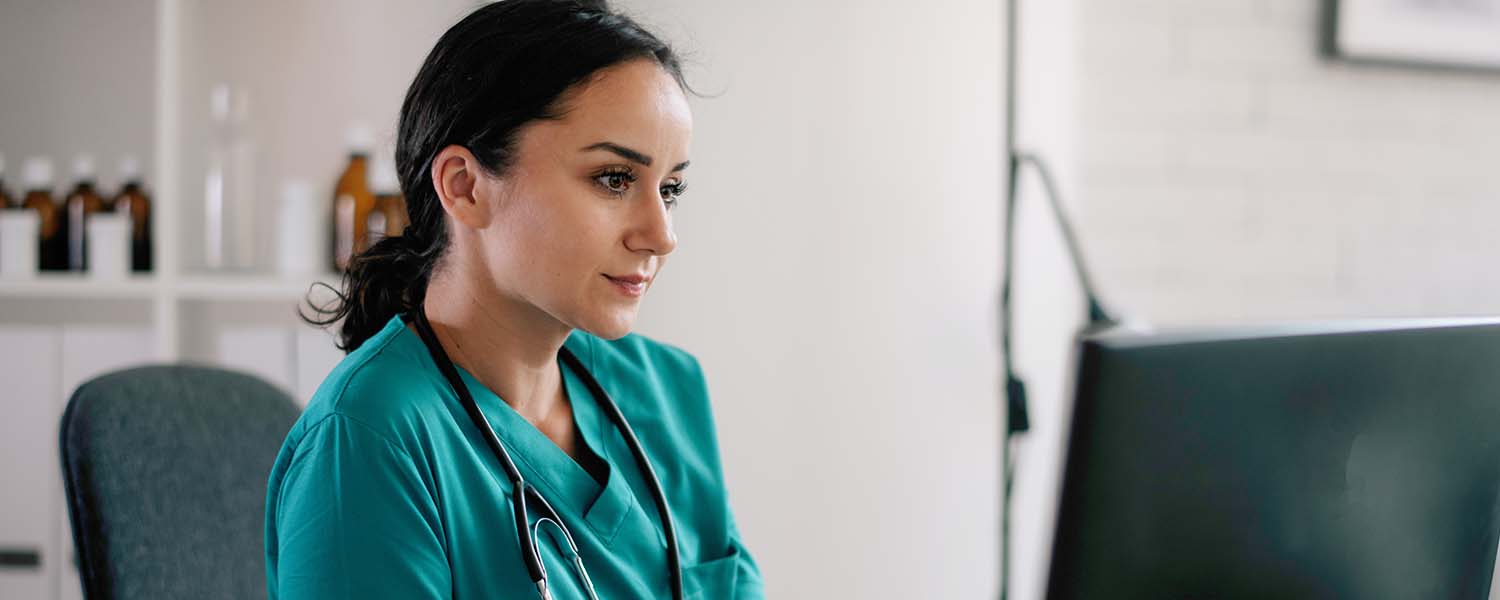 Health professional reading from her computer screen